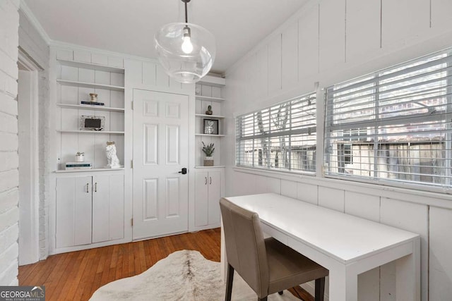 office area featuring crown molding, built in features, and light wood-type flooring