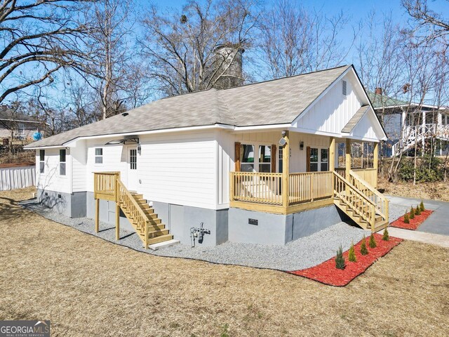 rear view of house featuring a porch