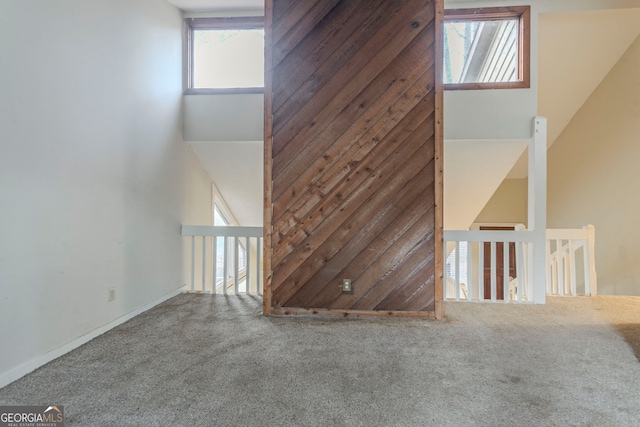 interior space featuring a towering ceiling and carpet flooring