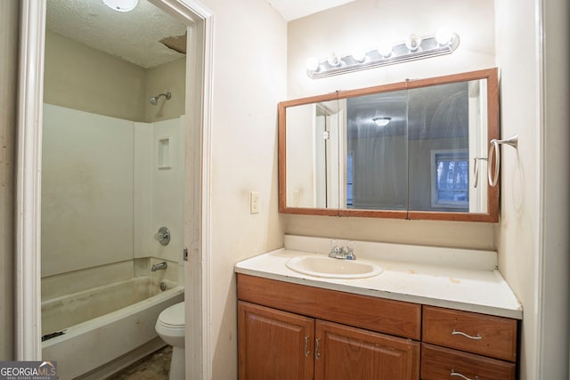 full bathroom featuring vanity, toilet, a textured ceiling, and shower / bathing tub combination