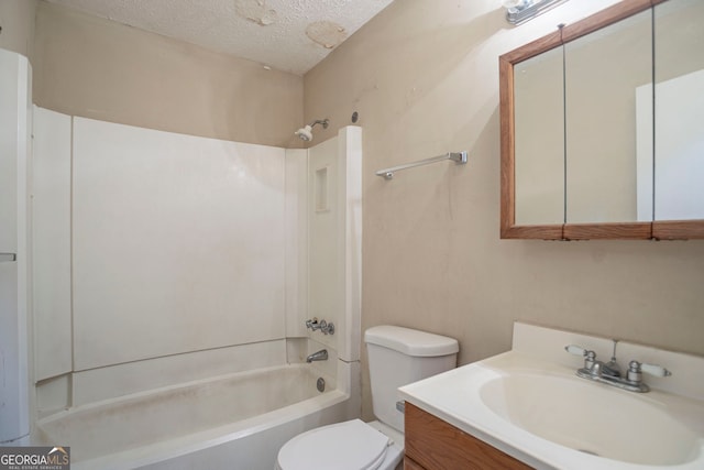 full bathroom with vanity, shower / washtub combination, a textured ceiling, and toilet