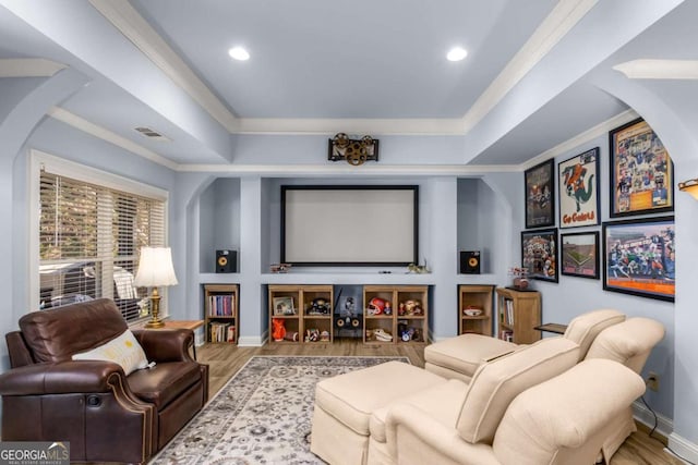 cinema featuring hardwood / wood-style floors and ornamental molding