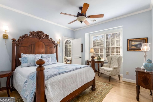 bedroom with hardwood / wood-style floors, crown molding, and ceiling fan