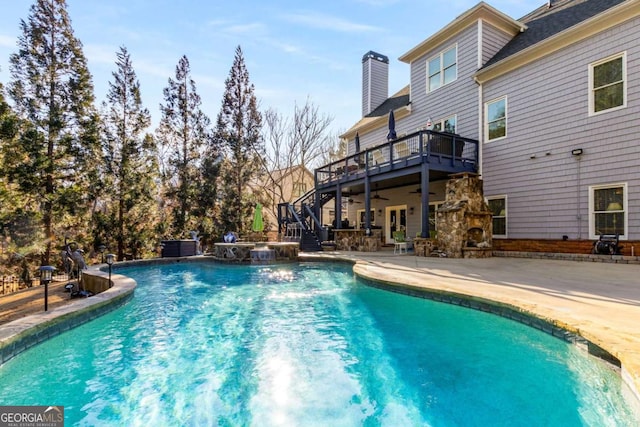 view of pool featuring ceiling fan, a fireplace, and a patio area