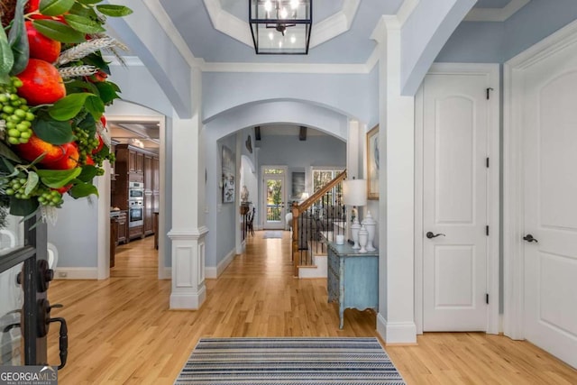 foyer featuring crown molding and light wood-type flooring