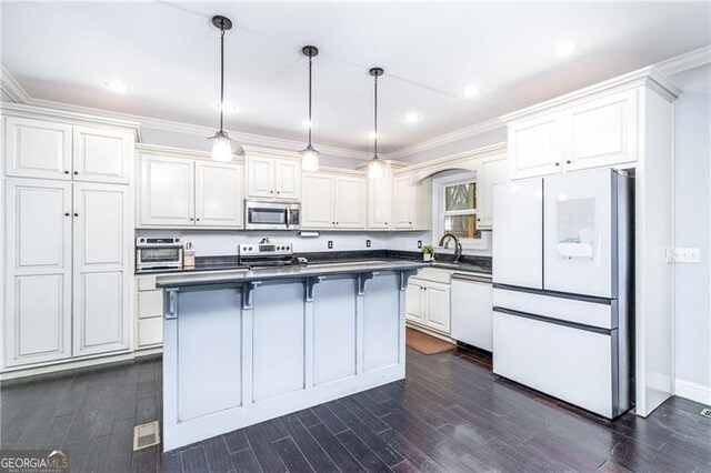 4801 Daniel Mill Rd, Winston, GA 30187 - kitchen featuring stainless steel appliances, white cabinets, dark countertops, dark wood-style floors, and a center island