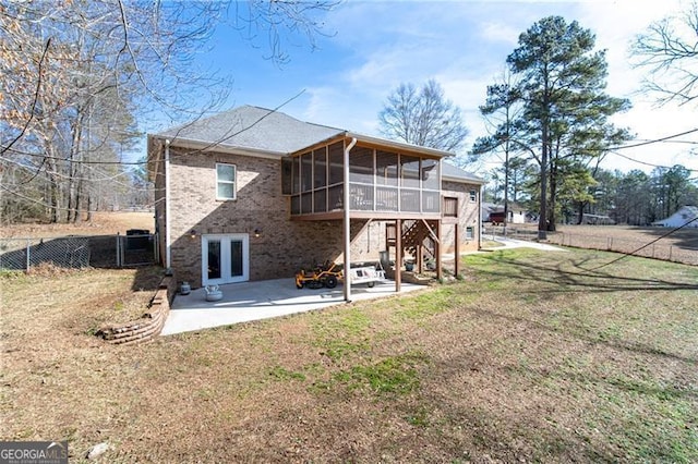 4801 Daniel Mill Rd, Winston, GA 30187 - back of house with a sunroom, a patio area, a yard, a fenced backyard, and brick siding