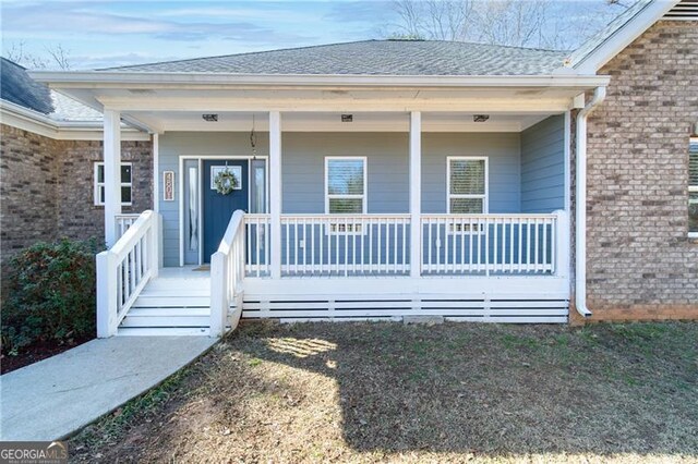 4801 Daniel Mill Rd, Winston, GA 30187 - doorway to property featuring roof with shingles, covered porch, and brick siding