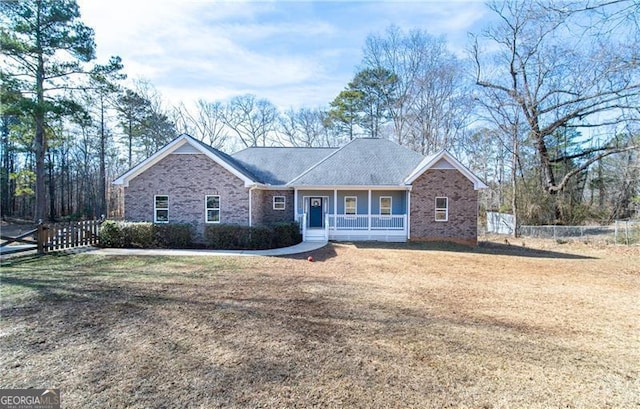 4801 Daniel Mill Rd, Winston, GA 30187 - view of front facade with brick siding, a porch, fence, and a front yard
