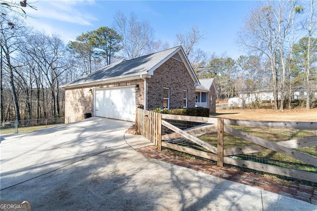 4801 Daniel Mill Rd, Winston, GA 30187 - view of side of property with fence, concrete driveway, brick siding, and a garage
