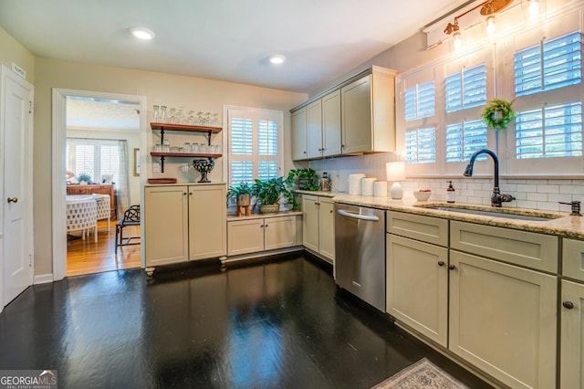 kitchen with a wealth of natural light, sink, stainless steel dishwasher, and dark wood-type flooring