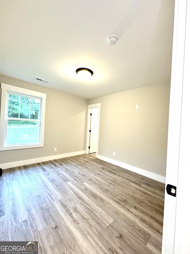 empty room with wood-type flooring