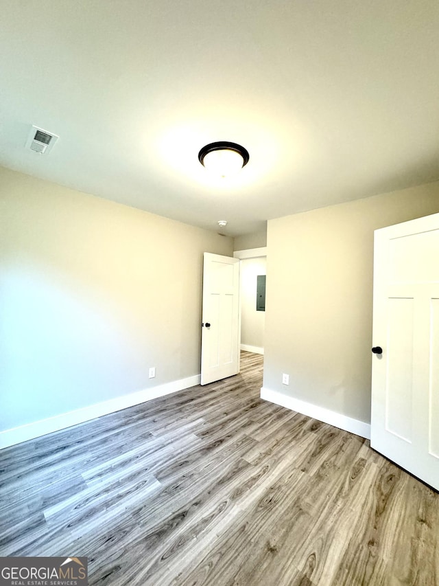 spare room with light hardwood / wood-style floors