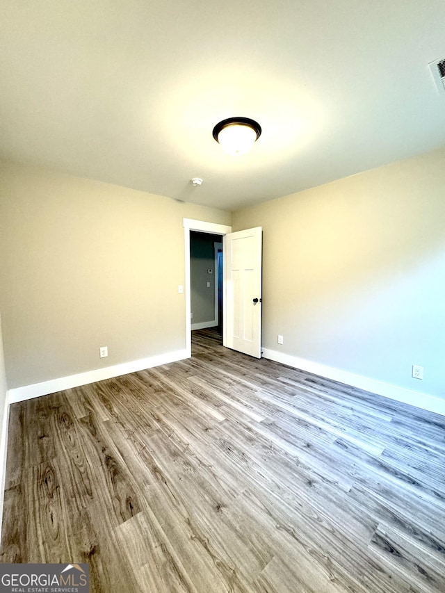 unfurnished room with light wood-type flooring