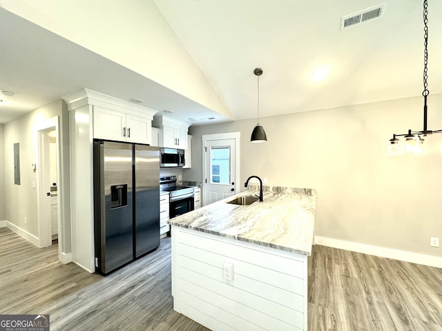 kitchen featuring appliances with stainless steel finishes, pendant lighting, sink, white cabinets, and light stone countertops