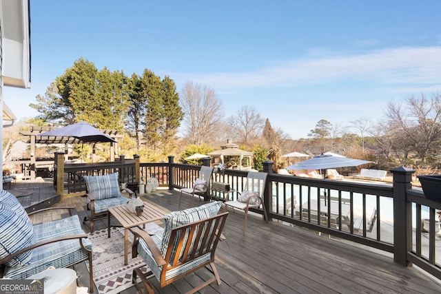 wooden terrace featuring an outdoor living space and a gazebo