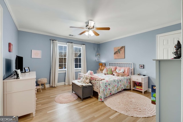 bedroom with ceiling fan, ornamental molding, and light wood-type flooring