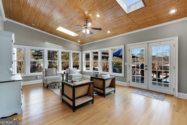 living room with wood ceiling, ornamental molding, vaulted ceiling with skylight, and light wood-type flooring