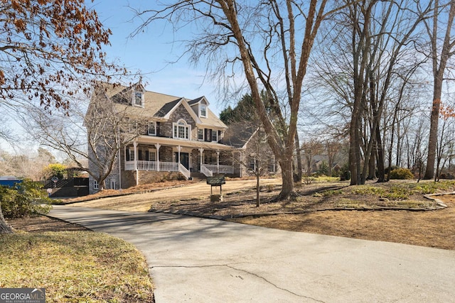 new england style home featuring a porch