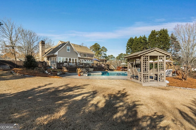 back of house featuring a gazebo and a pool side deck