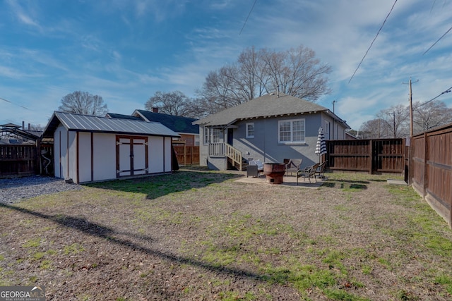 rear view of house with a shed and a lawn