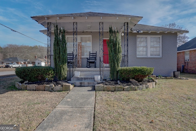 view of front of house with a porch and a front lawn