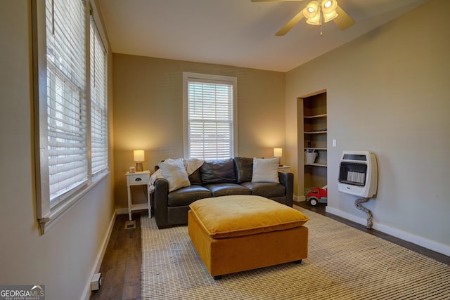 living room featuring hardwood / wood-style flooring, heating unit, built in features, and ceiling fan