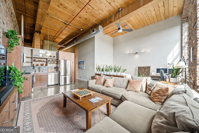 living room with beamed ceiling, a towering ceiling, wooden ceiling, and ceiling fan