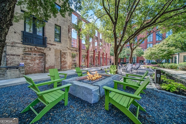 view of community featuring a patio and a fire pit