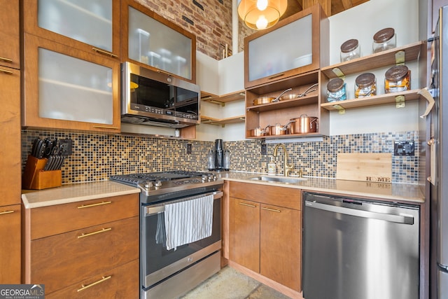 kitchen with tasteful backsplash, sink, and appliances with stainless steel finishes