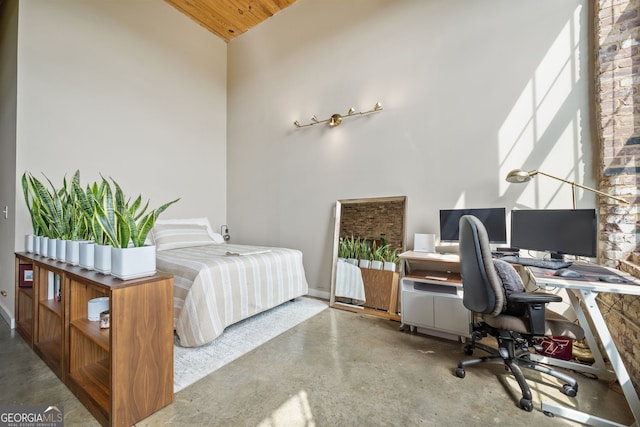 bedroom with concrete floors and high vaulted ceiling