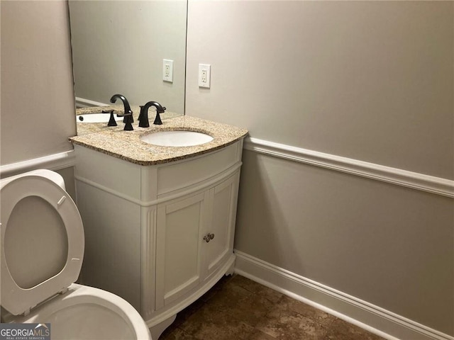 bathroom with vanity and toilet