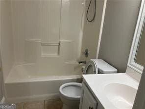 full bathroom with vanity, tub / shower combination, tile patterned floors, and toilet