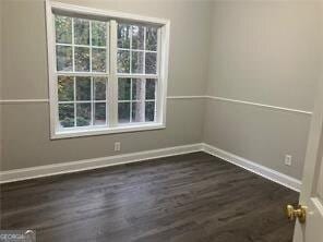 spare room featuring dark wood-type flooring