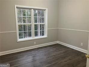 unfurnished room featuring dark hardwood / wood-style floors