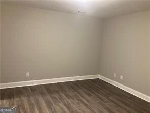 empty room featuring dark wood-type flooring