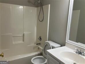 full bathroom with toilet, vanity, and  shower combination