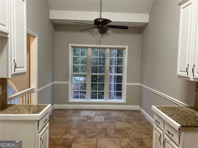 unfurnished dining area featuring ceiling fan