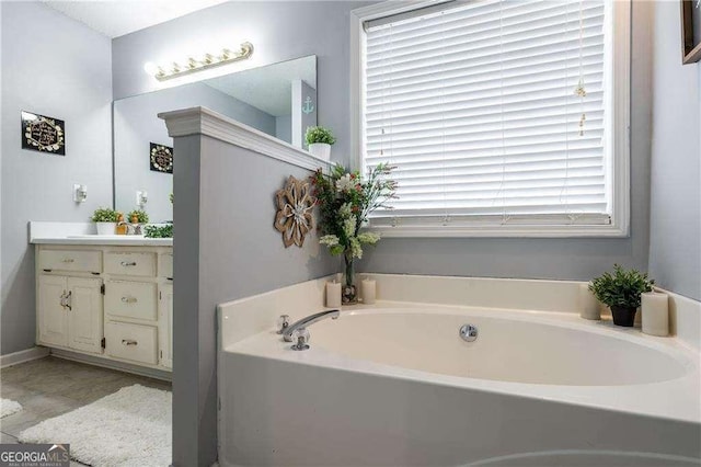 bathroom with vanity, a washtub, and plenty of natural light