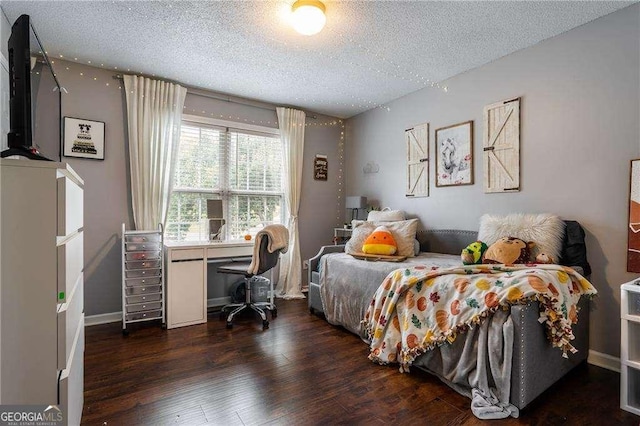 bedroom featuring dark hardwood / wood-style floors and a textured ceiling