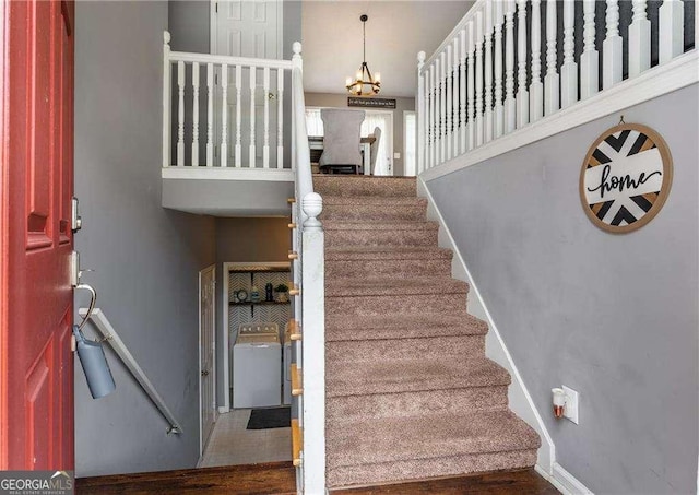 staircase with a chandelier