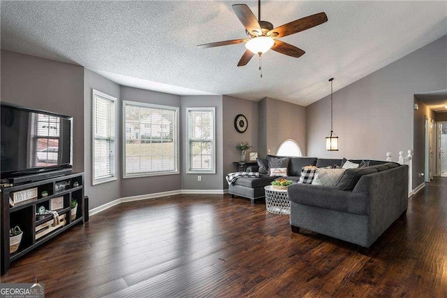 living room featuring ceiling fan, vaulted ceiling, dark hardwood / wood-style floors, and a textured ceiling