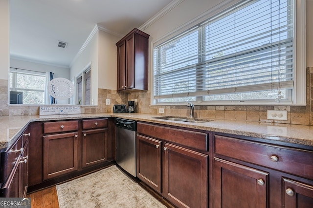 kitchen with a sink, visible vents, ornamental molding, stainless steel dishwasher, and tasteful backsplash