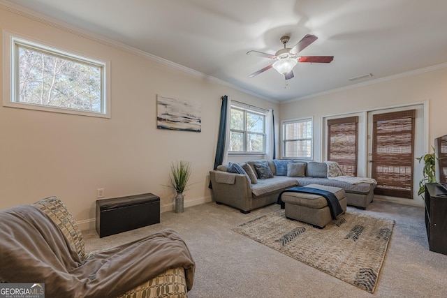 living room with ornamental molding, visible vents, ceiling fan, and baseboards