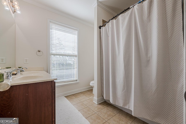 full bath featuring double vanity, toilet, tile patterned floors, crown molding, and a sink