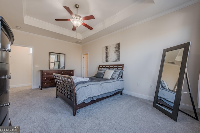 bedroom featuring baseboards, a raised ceiling, crown molding, and light colored carpet