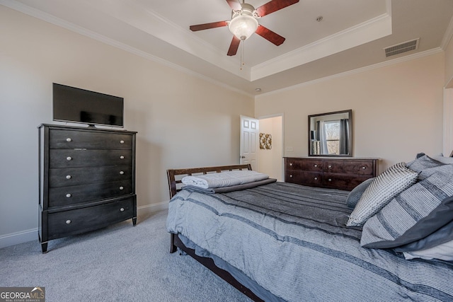 bedroom featuring a raised ceiling, visible vents, ornamental molding, light carpet, and baseboards