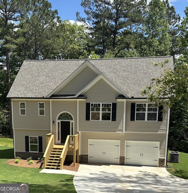29 Iron Bound Trl, Dallas, GA 30132 - raised ranch with a garage, stone siding, driveway, a shingled roof, and a front lawn