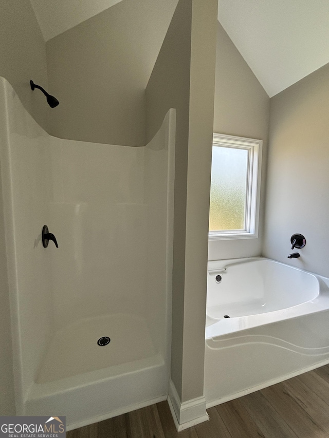 29 Iron Bound Trl, Dallas, GA 30132 - bathroom with wood finished floors, lofted ceiling, a garden tub, and a shower