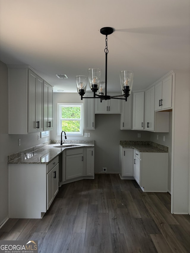 29 Iron Bound Trl, Dallas, GA 30132 - kitchen featuring a chandelier, dark wood finished floors, white cabinetry, stone counters, and decorative light fixtures